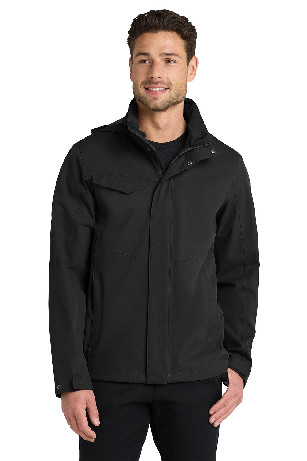 A man wearing a black softshell jacket with a high collar, zippered front, and flap chest pockets, photographed against a plain white studio background. Port Authority® Collective Outer Shell Jacket, Embroidered