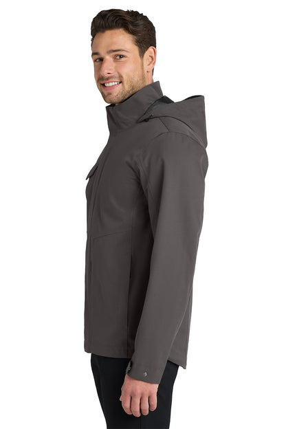 A man wearing a dark gray hooded jacket, shown in profile against a solid white background. Port Authority® Collective Outer Shell Jacket, Embroidered