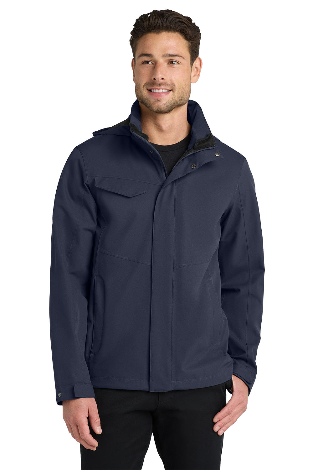 A man wearing a navy blue lightweight jacket over a black shirt and black pants, standing against a plain white background. Port Authority® Collective Outer Shell Jacket, Embroidered
