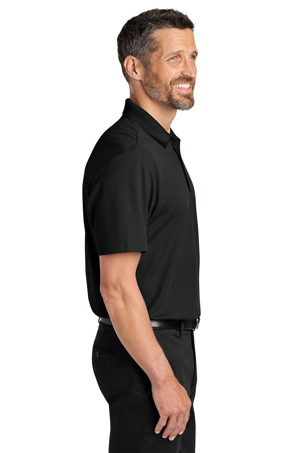 Man wearing a black polo shirt and pants on a white background. Port Authority® Plaited Pique Polo, Embroidered by Helmsman Stitch Co.