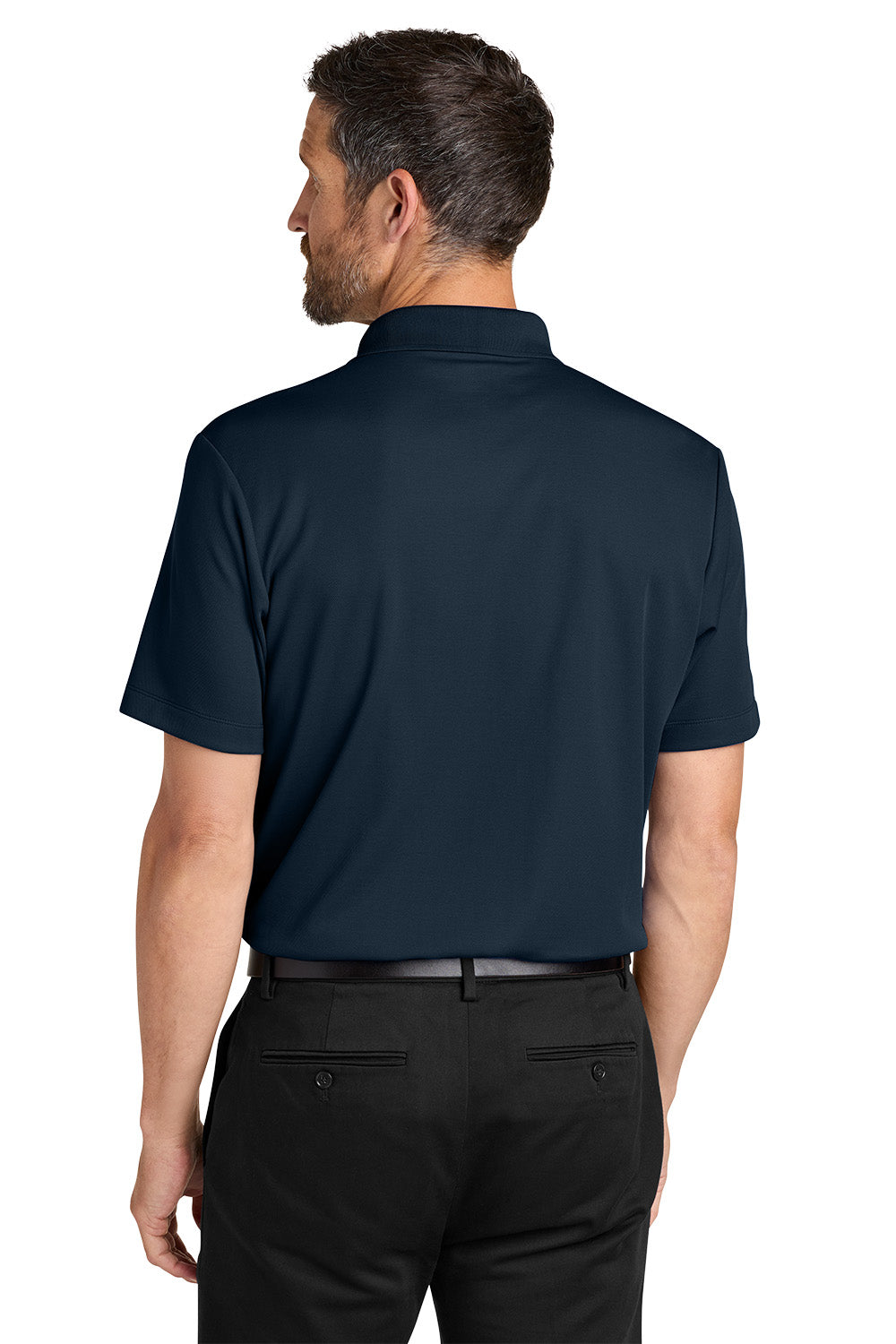 Man wearing a navy blue polo shirt and black pants on a white background. Port Authority® Plaited Pique Polo, Embroidered by Helmsman Stitch Co.