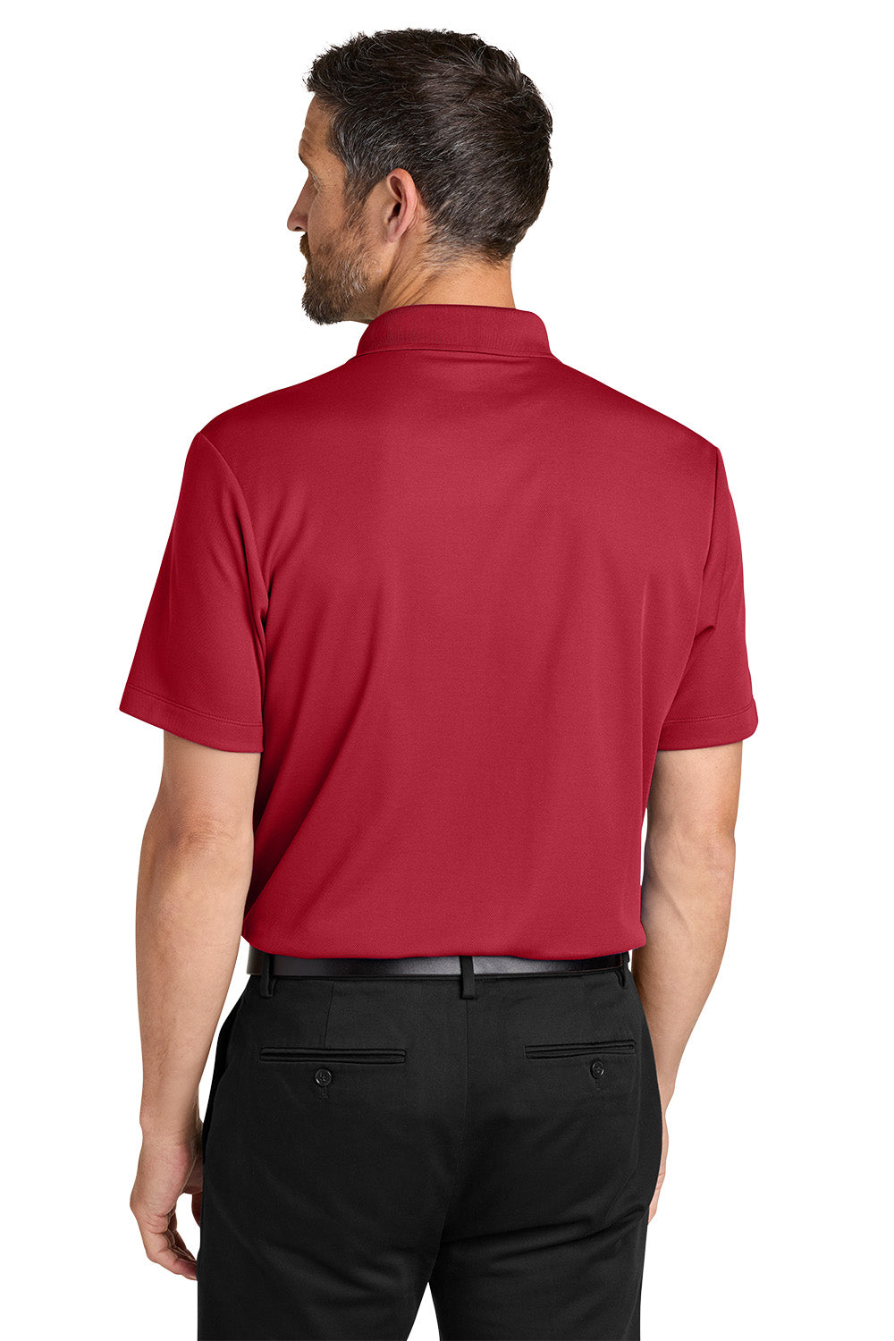 Man wearing a red polo shirt and black pants on a white background. Port Authority® Plaited Pique Polo, Embroidered by Helmsman Stitch Co.