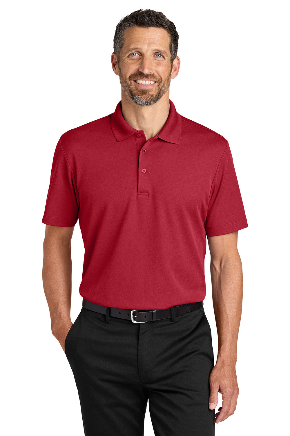 Man wearing a red polo shirt and black pants on a white background. Port Authority® Plaited Pique Polo, Embroidered by Helmsman Stitch Co.