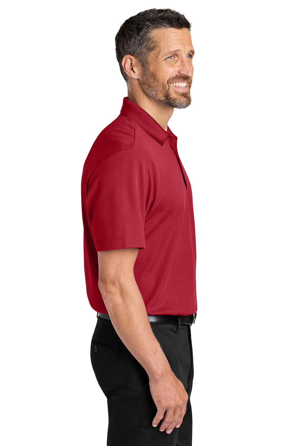 Man wearing a red polo shirt on a white background. Port Authority® Plaited Pique Polo, Embroidered by Helmsman Stitch Co.