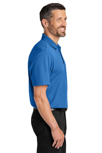 Man wearing a blue polo shirt on a white background. Port Authority® Plaited Pique Polo, Embroidered by Helmsman Stitch Co.