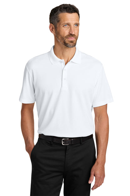 Man wearing a white polo shirt and black pants on a white background. Port Authority® Plaited Pique Polo, Embroidered by Helmsman Stitch Co.