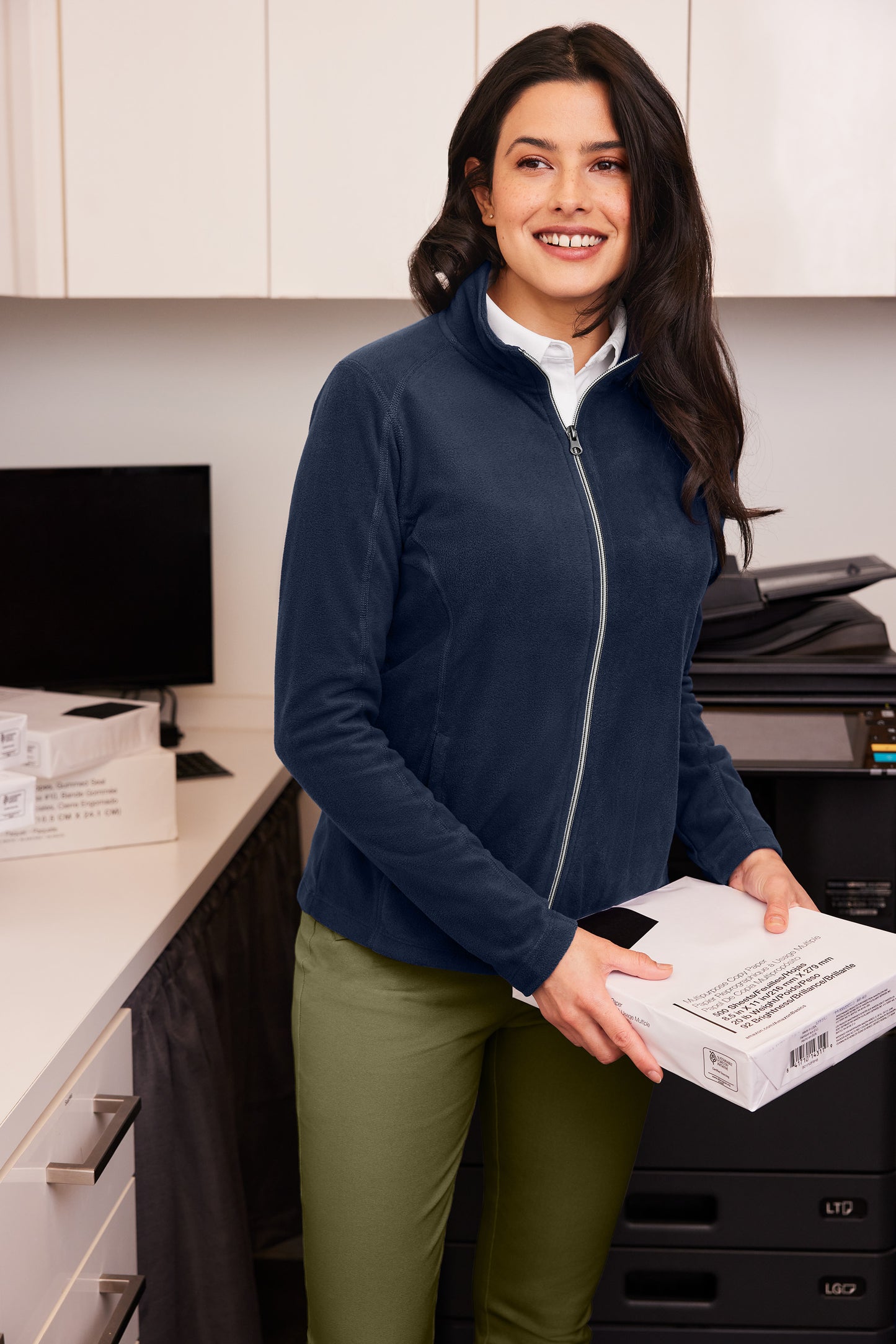 Woman holding a package in an office setting Port Authority® Women's Microfleece Jacket, Embroidered