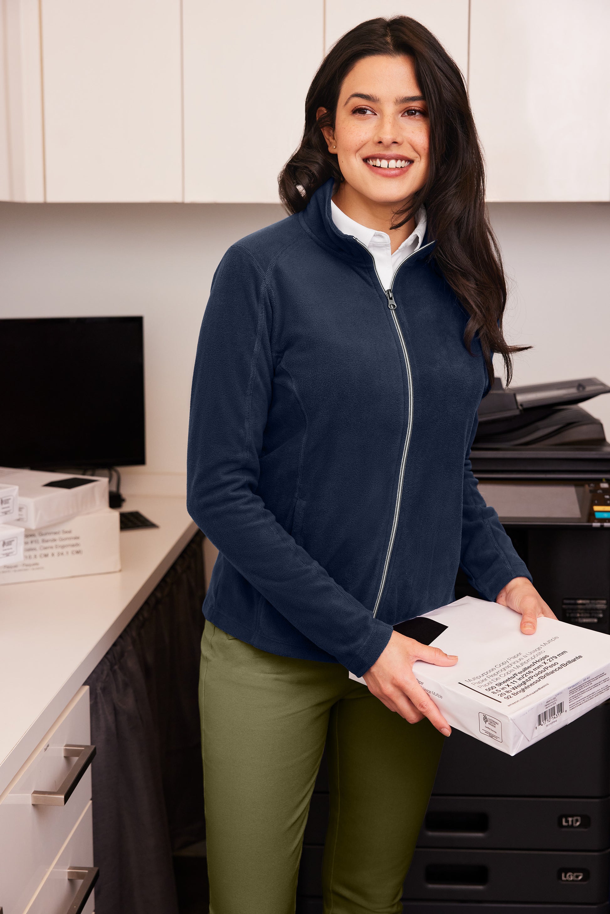 Woman holding a package in an office setting Port Authority® Women's Microfleece Jacket, Embroidered