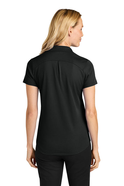 Woman wearing a black polo shirt on a white background. Port Authority® Women’s Plaited Pique Polo, Embroidered by Helmsman Stitch Co.