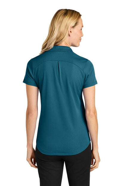 Woman wearing a teal polo shirt on a white background. Port Authority® Women’s Plaited Pique Polo, Embroidered by Helmsman Stitch Co.