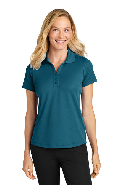 Woman wearing a teal polo shirt on a white background. Port Authority® Women’s Plaited Pique Polo, Embroidered by Helmsman Stitch Co.