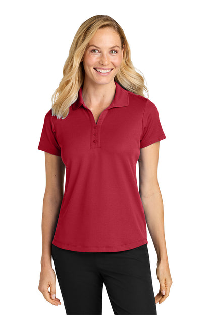 Woman wearing a red polo shirt on a white background. Port Authority® Women’s Plaited Pique Polo, Embroidered by Helmsman Stitch Co.