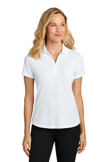 Woman wearing a white polo shirt and black pants on a white background. Port Authority® Women’s Plaited Pique Polo, Embroidered by Helmsman Stitch Co.