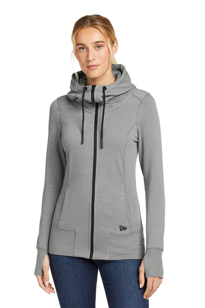 Woman wearing a gray hoodie with a brand logo on a white background, embroidered New Era® Woman's Tri-Blend Fleece Full-Zip Hoodie