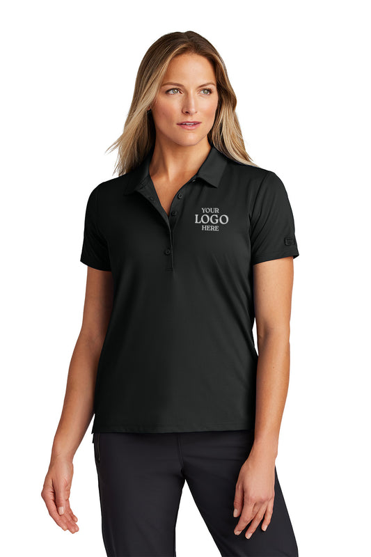 Woman wearing a black polo shirt with 'Your Logo Here' text on a white background, OGIO® Women's Regain Polo, Embroidered