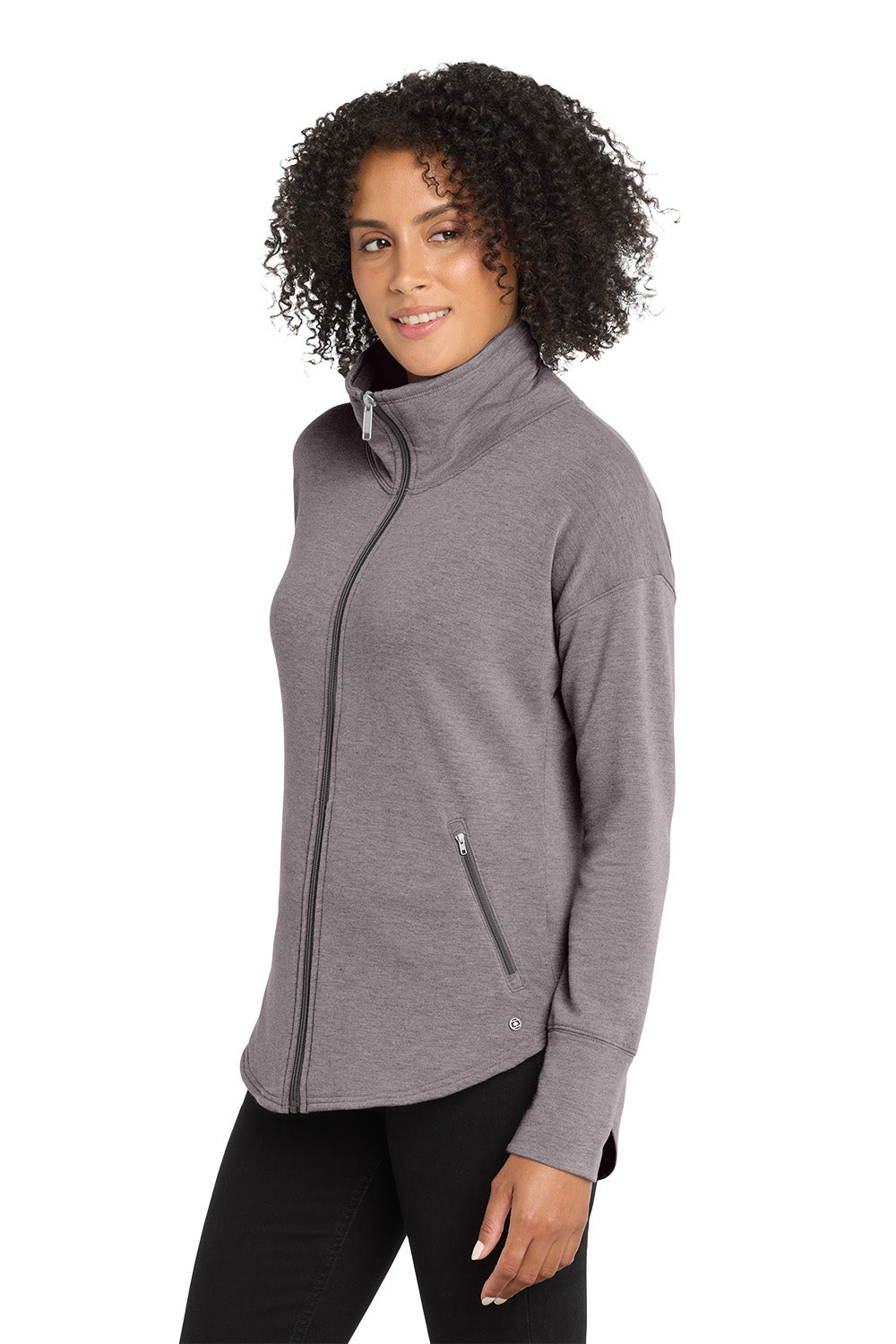 Woman wearing a gray zip-up jacket on a white background, embroidered OGIO® Women's Luuma Full-Zip Fleece