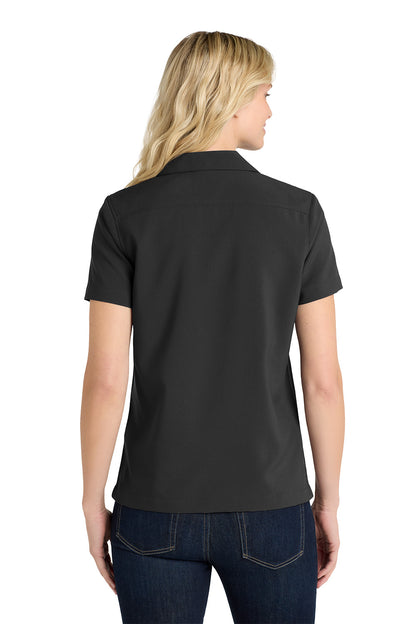 Person wearing a black polo shirt on a white background embroidered Port Authority® Women's Short Sleeve Performance Staff Shirt