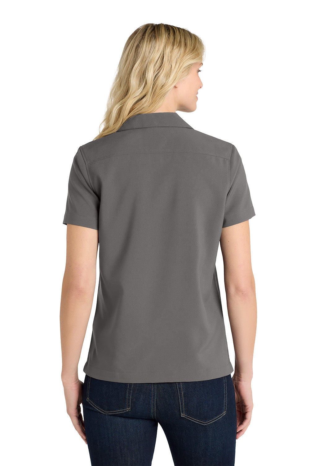 Woman wearing a gray polo shirt on a white background embroidered Port Authority® Women's Short Sleeve Performance Staff Shirt