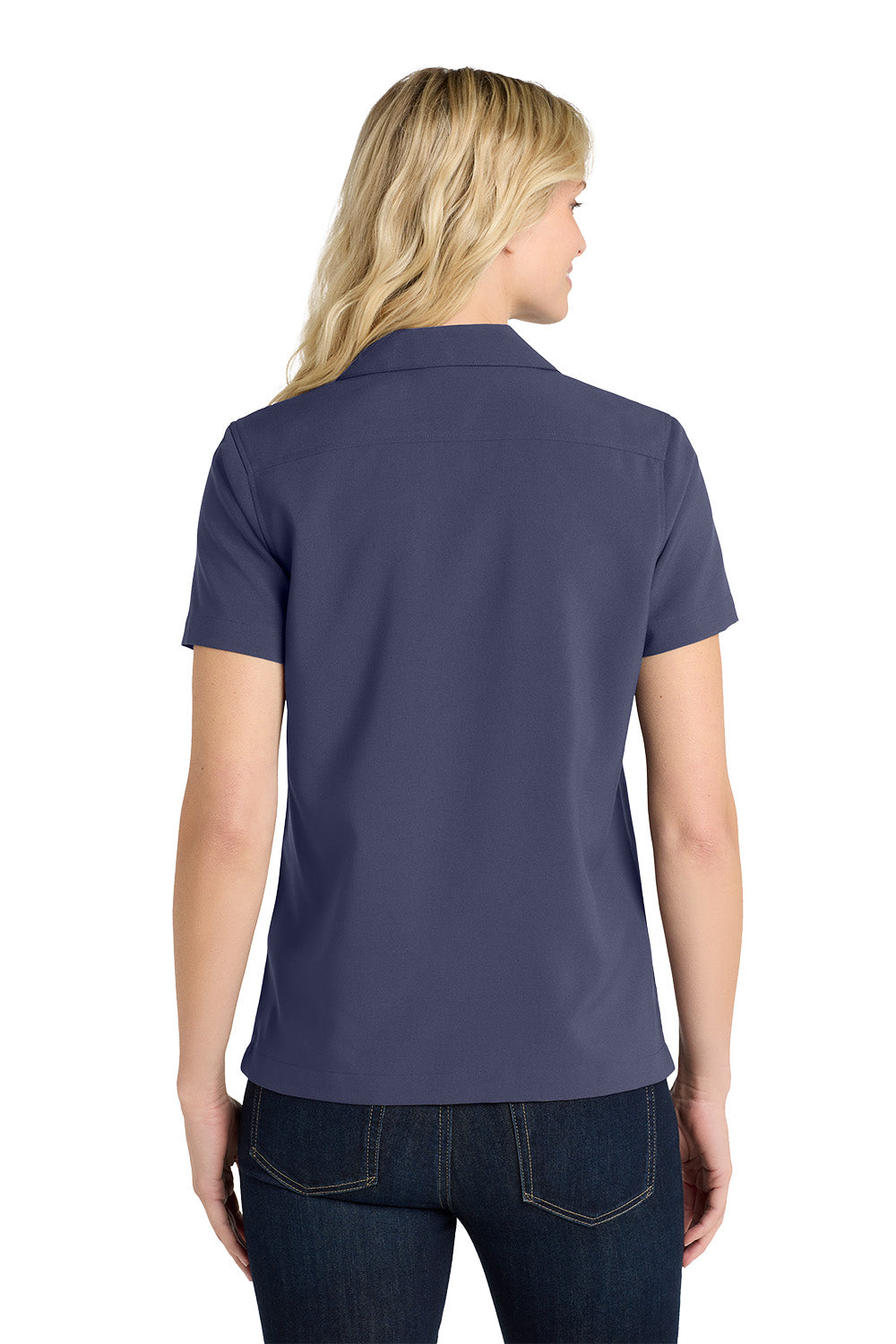 Person wearing a navy blue polo shirt on a white background embroidered Port Authority® Women's Short Sleeve Performance Staff Shirt