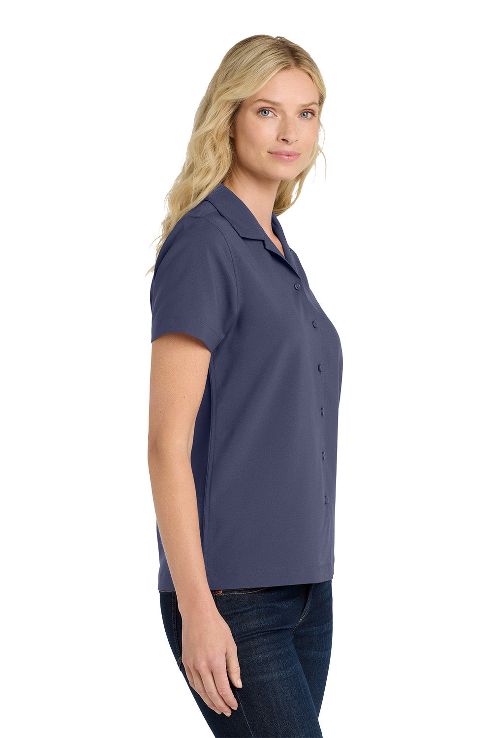 Woman wearing a navy blue polo shirt on a white background embroidered Port Authority® Women's Short Sleeve Performance Staff Shirt