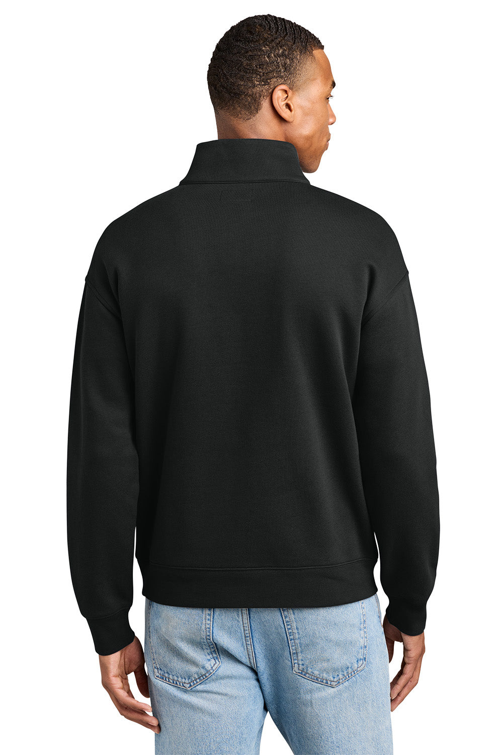 A man viewed from the back wearing a black long-sleeve quarter-zip pullover sweatshirt and light blue jeans, set against a plain white background. New Era® Heritage Fleece 1/2-Zip, Embroidered