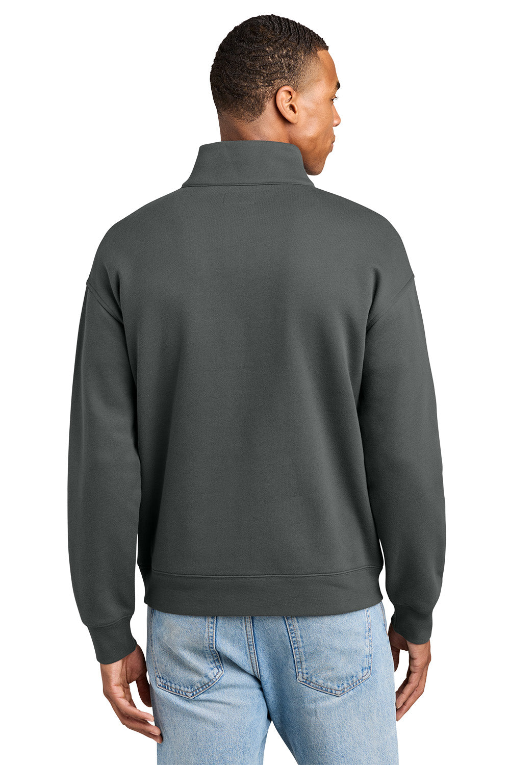 A man viewed from the back wearing a dark charcoal gray quarter-zip sweatshirt and light blue jeans, set against a plain white background. New Era® Heritage Fleece 1/2-Zip, Embroidered