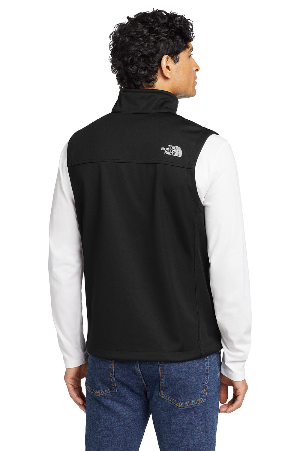 Person wearing a black vest with 'The North Face' logo on a white background, embroidered The North Face® Ridgewall Soft Shell Vest