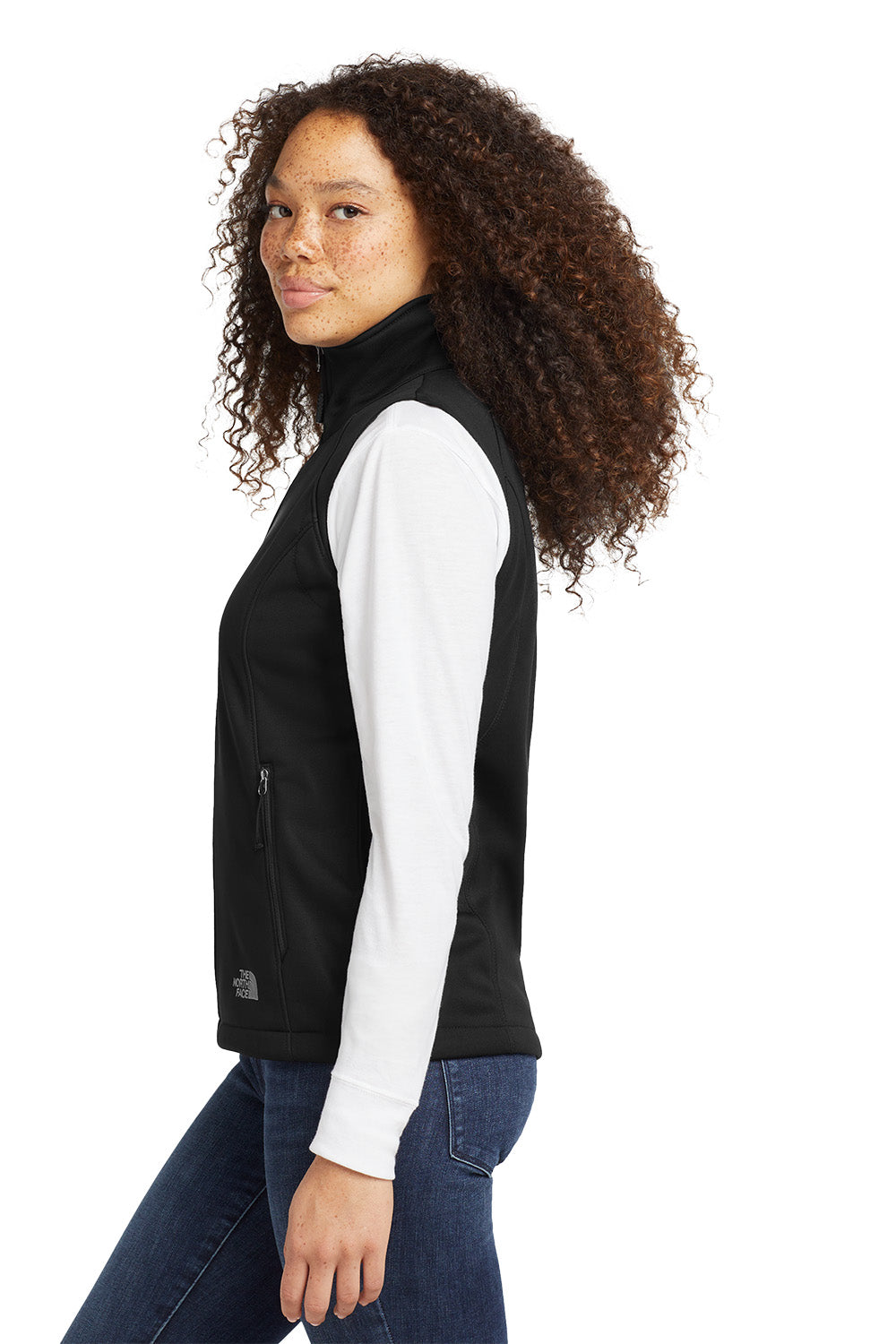 Woman wearing a black vest over a white shirt on a white background embroidered The North Face® Women's Ridgewall Soft Shell Vest