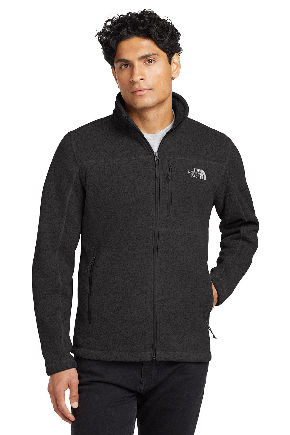 Man wearing a black jacket with a brand logo on a white background embroidered The North Face® Sweater Fleece Jacket