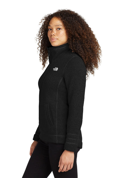 Person wearing a black fleece jacket with a brand logo on a white background embroidered The North Face® Women's Sweater Fleece Jacket
