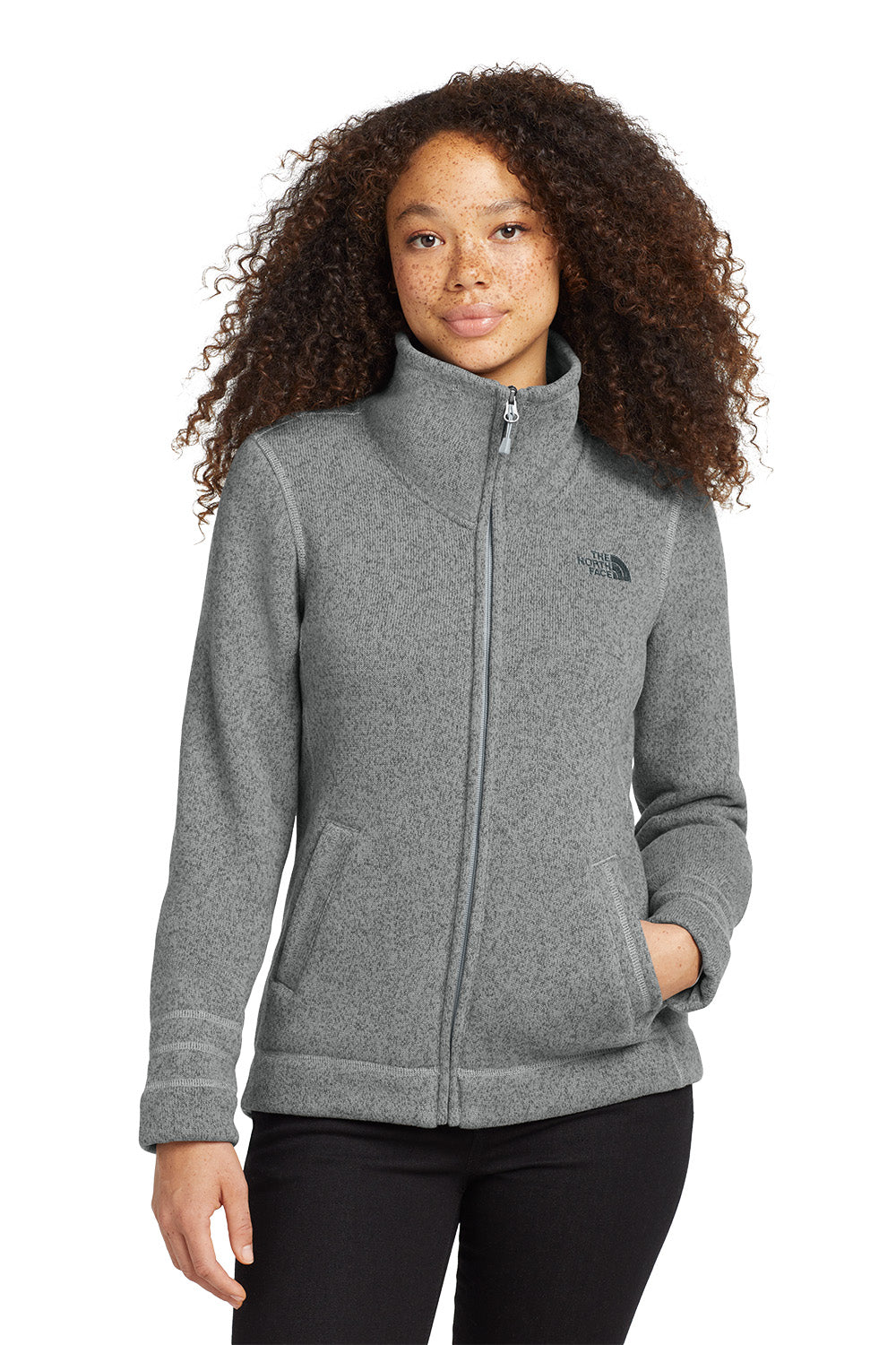 Woman wearing a gray fleece jacket with a brand logo on a white background embroidered The North Face® Women's Sweater Fleece Jacket