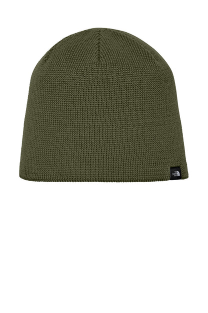 An olive green ribbed knit beanie hat with a small black and white The North Face logo patch on the side, shown against a plain white background. The North Face® Mountain Beanie, Embroidered