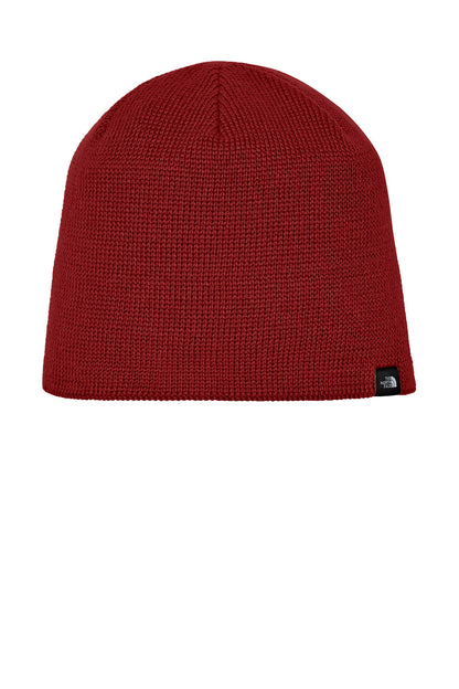 Red knit beanie with a brand logo on a white background The North Face® Mountain Beanie, Embroidered