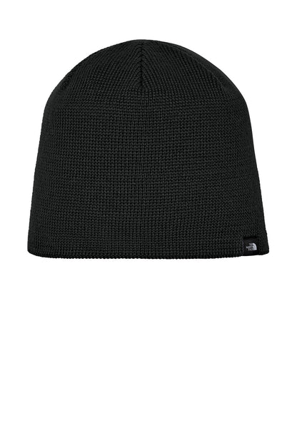 A black ribbed knit beanie hat with a small black embroidered logo of The North Face on the lower right side, shown against a plain white background. The North Face® Mountain Beanie, Embroidered