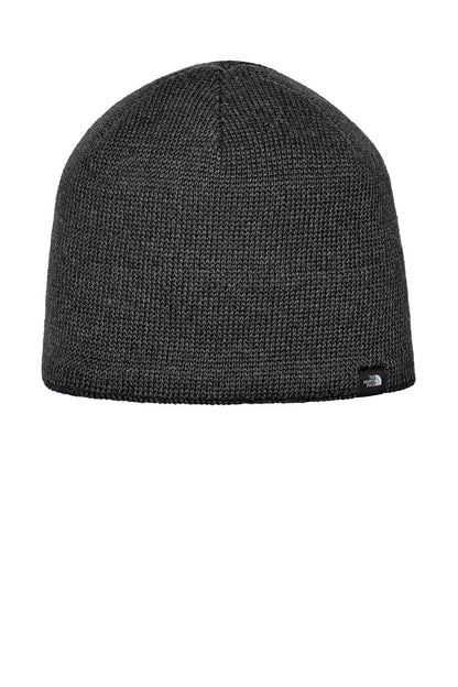 A dark gray heathered knit beanie hat with a small black embroidered logo on the lower right side, shown against a plain white background. The North Face® Mountain Beanie, Embroidered