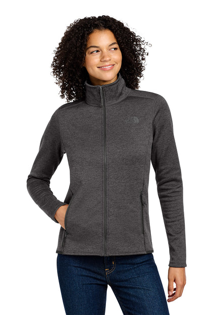 Woman wearing a gray jacket with a brand logo on a white background embroidered The North Face® Women's Skyline Full-Zip Fleece Jacket