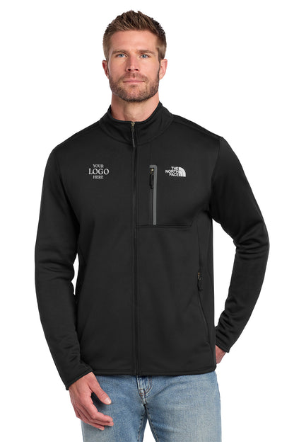 Man wearing a black jacket with logos on a white background embroidered The North Face® Skyline Full-Zip Fleece Jacket