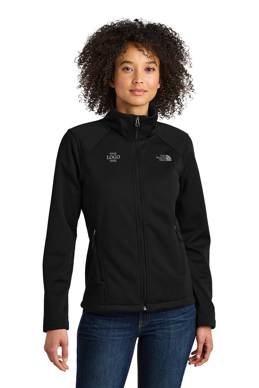Woman wearing a black jacket with a logo on a white background embroidered The North Face® Women's Chest Logo Ridgewall Soft Shell Jacket