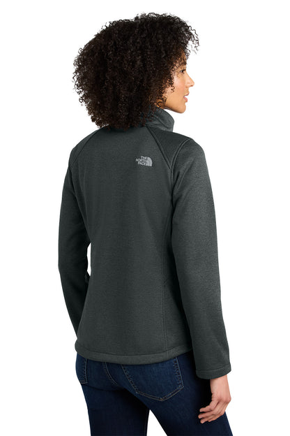 Person wearing a gray jacket with a brand logo on the back, standing against a white background embroidered The North Face® Women's Chest Logo Ridgewall Soft Shell Jacket