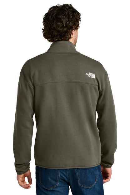 Person wearing a green fleece jacket with a brand logo on the back, standing against a white background, embroidered The North Face® Double-Knit 1/2-Zip Fleece