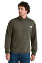 Man wearing a green half-zip sweatshirt with a brand logo on a white background, embroidered The North Face® Double-Knit 1/2-Zip Fleece