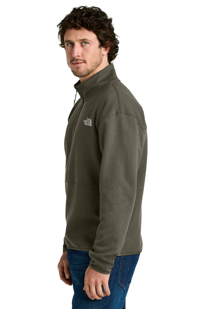 Man wearing a green fleece jacket with a logo on a white background, embroidered The North Face® Double-Knit 1/2-Zip Fleece