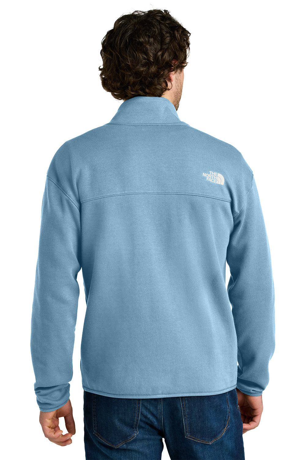Person wearing a light blue fleece jacket with a brand logo on the back, standing against a white background. embroidered The North Face® Double-Knit 1/2-Zip Fleece