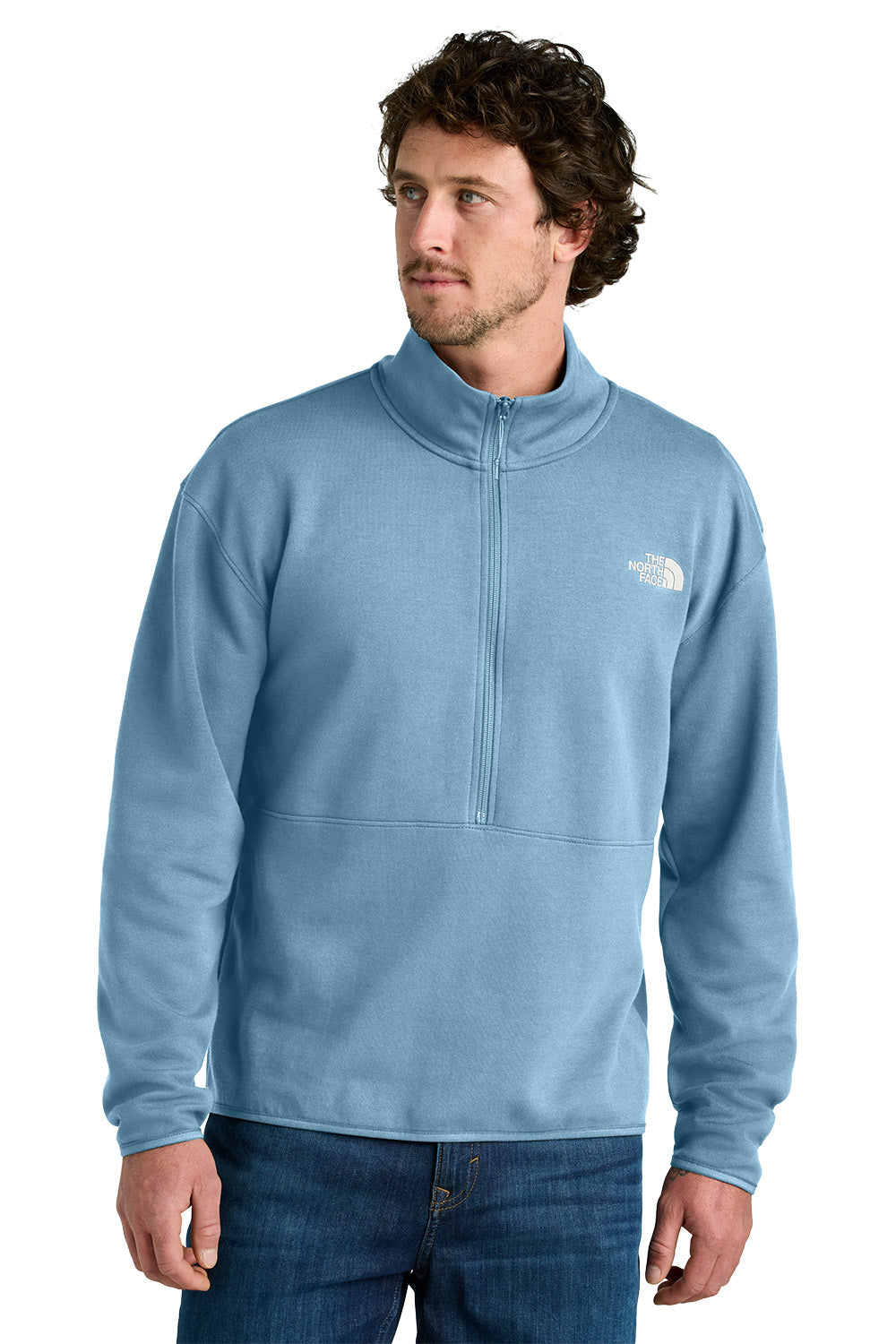 Man wearing a light blue pullover with a brand logo on a white background embroidered The North Face® Double-Knit 1/2-Zip Fleece