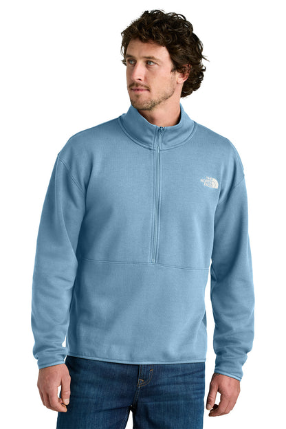 Man wearing a light blue pullover with a brand logo on a white background embroidered The North Face® Double-Knit 1/2-Zip Fleece
