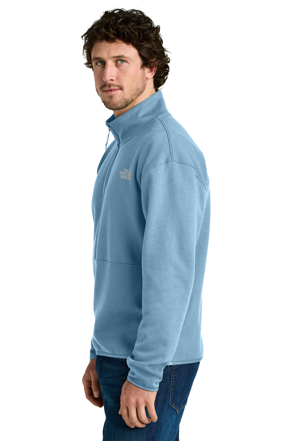 Man wearing a light blue fleece jacket with a brand logo on a white background embroidered The North Face® Double-Knit 1/2-Zip Fleece
