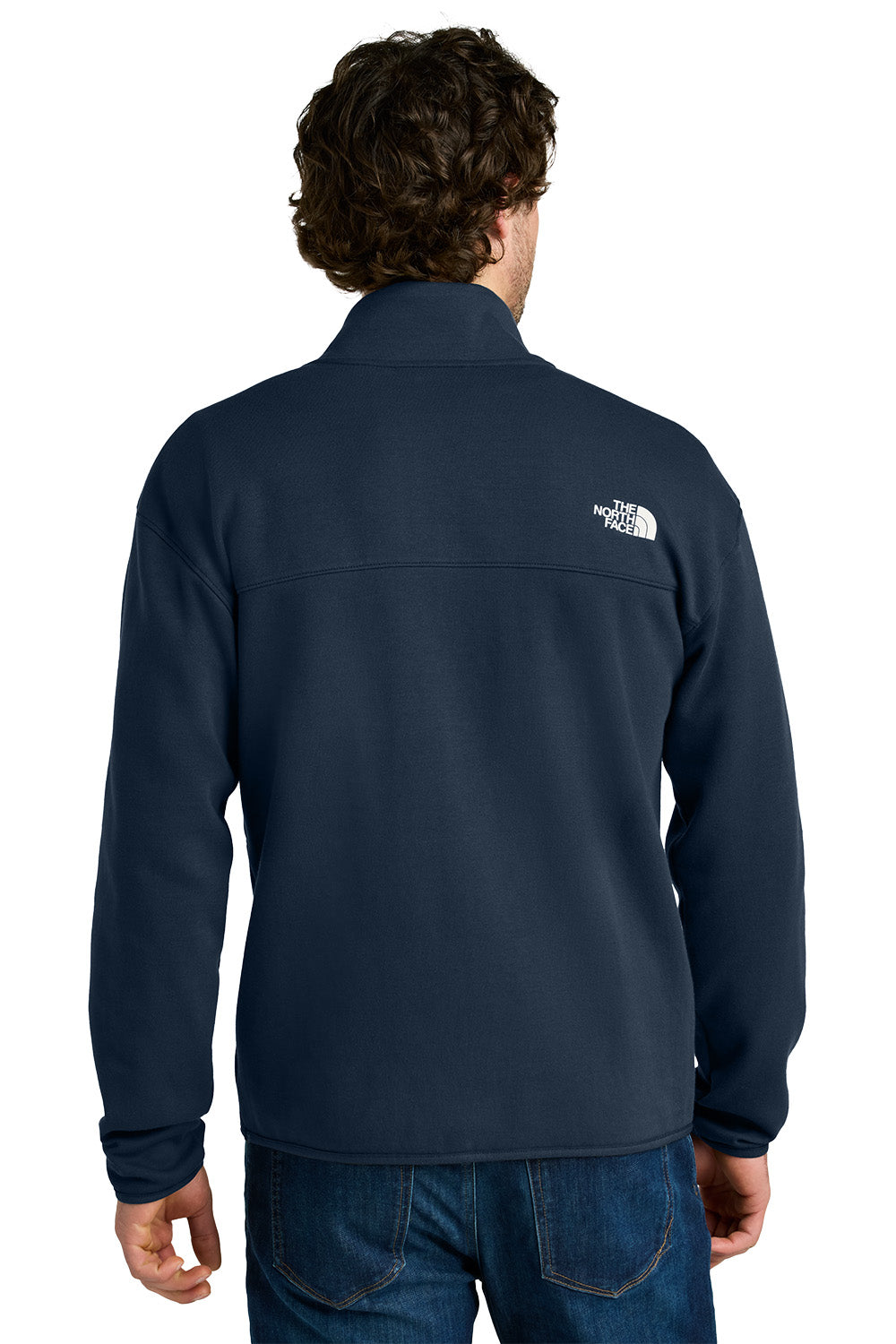 Person wearing a navy blue jacket with a brand logo on the back, standing against a white background embroidered The North Face® Double-Knit 1/2-Zip Fleece