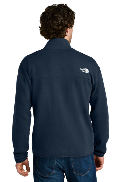 Person wearing a navy blue jacket with a brand logo on the back, standing against a white background embroidered The North Face® Double-Knit 1/2-Zip Fleece