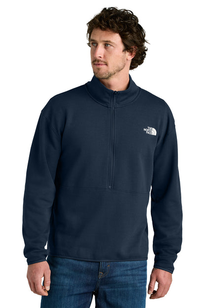 Man wearing a navy blue pullover with a brand logo on a white background embroidered The North Face® Double-Knit 1/2-Zip Fleece