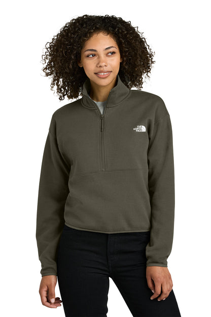 Woman wearing a green pullover with a logo on a white background embroidered The North Face® Women's Double-Knit 1/2-Zip Fleece